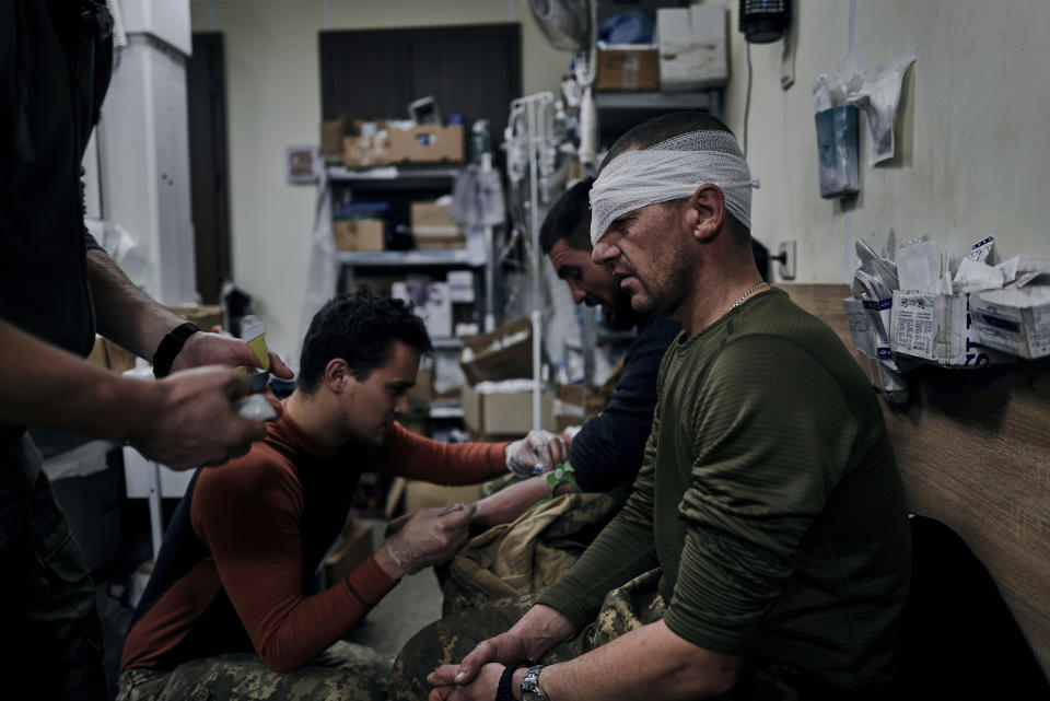 Ukrainian soldiers receive first aid in a hospital in Bakhmut, Donetsk region, Ukraine, Wednesday, Nov. 9, 2022. (AP Photo/LIBKOS)