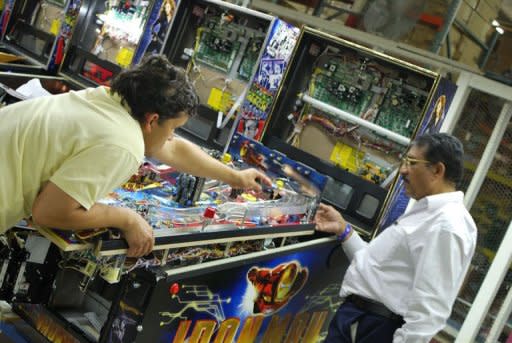 Workers at Stern Pinball assemble an Iron Man machine in Chicago on August 15, 2011. Each machine uses over a half a mile of wire and it takes more than 30 hours to assemble the 3,500 or so parts