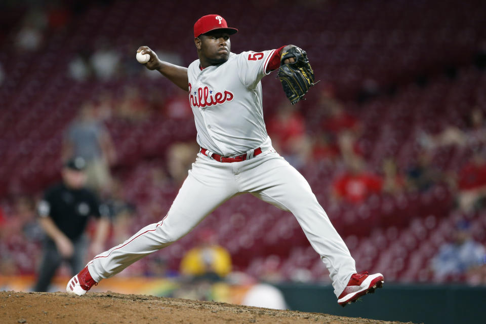 FILE - In this Sept. 3, 2019, file photo, Philadelphia Phillies relief pitcher Hector Neris throws against the Cincinnati Reds during the ninth inning of a baseball game in Cincinnati. Neris avoided a salary arbitration hearing with the Phillies by agreeing to a $4.6 million, one-year contract. The deal reached Thursday night, Feb. 20, 2020, includes a $7 million team option for 2021 with no buyout. (AP Photo/Gary Landers, File)