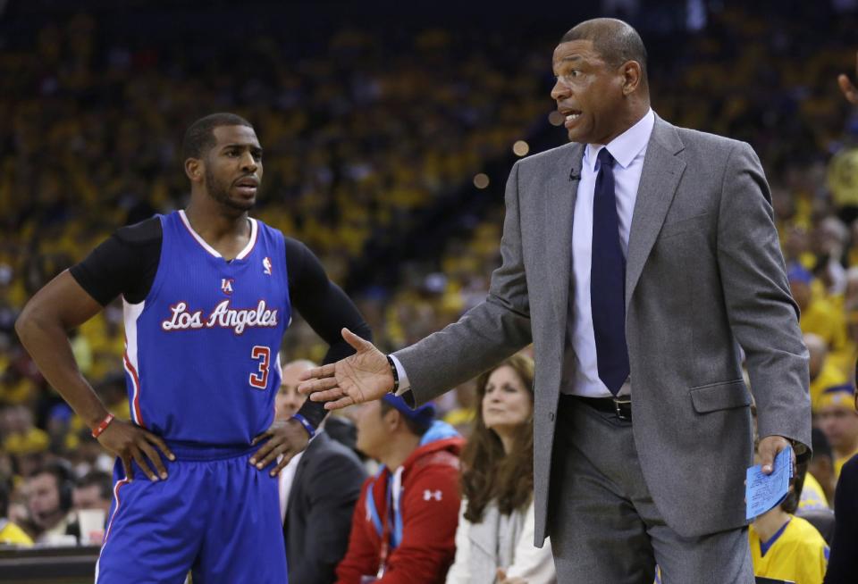 Los Angeles Clippers guard Chris Paul, left, talks to head coach Doc Rivers during the first half in Game 4 of an opening-round NBA basketball playoff series against the Golden State Warriors on Sunday, April 27, 2014, in Oakland, Calif. (AP Photo/Marcio Jose Sanchez)