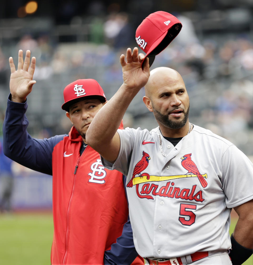 St. Louis Cardinals first baseman Albert Pujols (5) and catcher Yadier Molina acknowledge the New York Mets crowd during a pre-game ceremony before a baseball game on Thursday, May 19, 2022, in New York. (AP Photo/Adam Hunger)