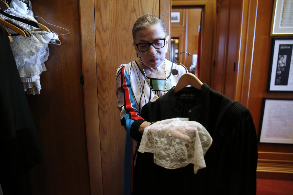 Ginsburg showing the collar she wears with her robes in courtroom sessions, in her chambers at the Supreme Court. (Photo: Jonathan Ernst/Reuters)