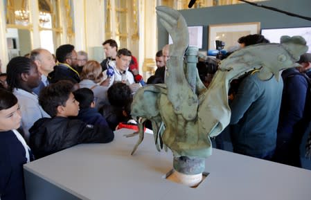 The iconic copper rooster, which was perched at the top of the spire of Notre-Dame Cathedral for more than a century is displayed at the exhibition "Revoir Notre-Dame de Paris\