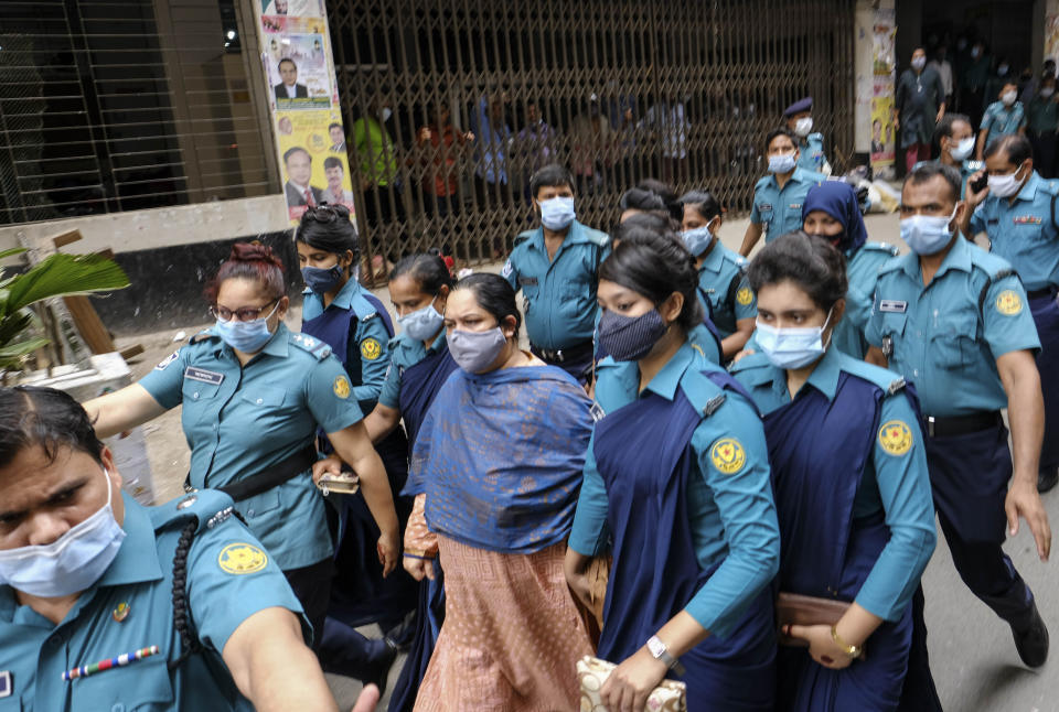 Bangladeshi journalist Rozina Islam, center, is escorted by police to a court in Dhaka, Bangladesh, Tuesday, May 18, 2021. Police in Bangladesh's capital have arrested the prominent journalist on charges of stealing and photographing sensitive state information. (AP Photo/Mahmud Hossain Opu)