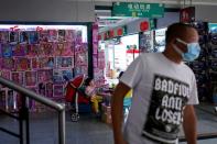 A man wearing face mask walks past a toy products stall at the Yiwu Wholesale Market following an outbreak of the novel coronavirus disease (COVID-19), in Yiwu