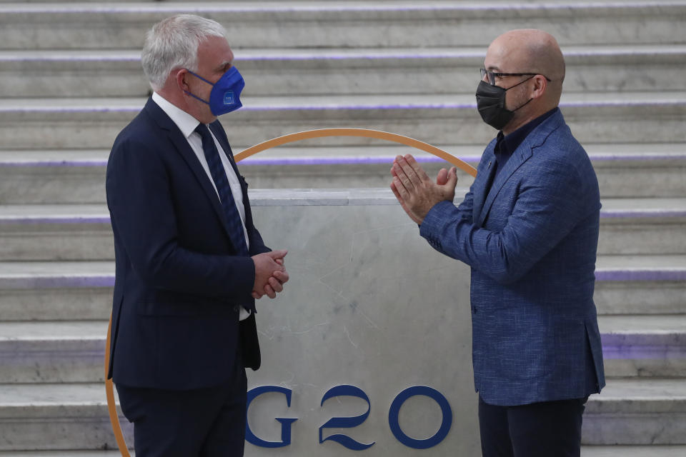 German undersecretary of environment Jochen Flasbarth is welcomed by Italian Minister for Ecological Transition Roberto Cingolani as he arrives at Palazzo Reale in Naples, Italy, Thursday, July 22, 2021, to take part in a G20 meeting on environment, climate and energy. (AP Photo/Salvatore Laporta)