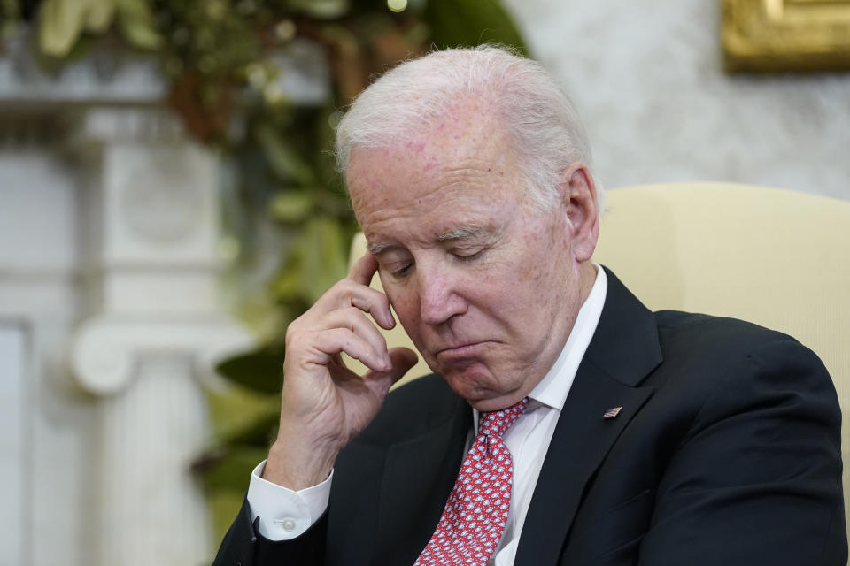 President Joe Biden listens during a meeting with Ecuador's President Guillermo Lasso in the Oval Office of the White House, Monday, Dec. 19, 2022, in Washington. (AP Photo/Patrick Semansky)