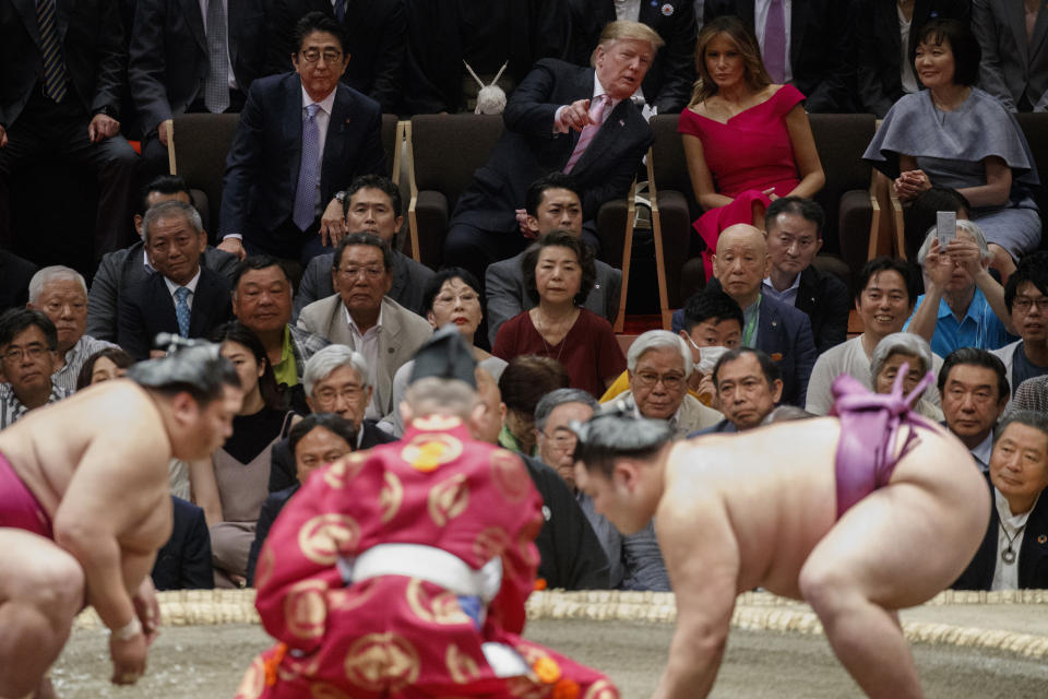 President Donald Trump talks with first lady Melania Trump as he attends the Tokyo Grand Sumo Tournament with Japanese Prime Minister Shinzo Abe and his wife Akie Abe, top right, at Ryogoku Kokugikan Stadium, Sunday, May 26, 2019, in Tokyo. (AP Photo/Evan Vucci)