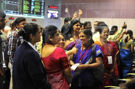 Indian Space Research Organization (ISRO) scientists and engineers cheer after India's Mars orbiter successfully entered the red planet's orbit, at their Spacecraft Control Center, in this photo taken through a glass panel, in Bangalore September 24, 2014. REUTERS/Abhishek N. Chinnappa