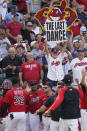 A Cleveland Indians fan holds up a sign as the team celebrates after defeating the Kansas City Royals in a baseball game, Monday, Sept. 27, 2021, in Cleveland. Cleveland played its final home game against the Royals as the Indians, the team's nickname since 1915. The club will be called the Cleveland Guardians next season. (AP Photo/Tony Dejak)