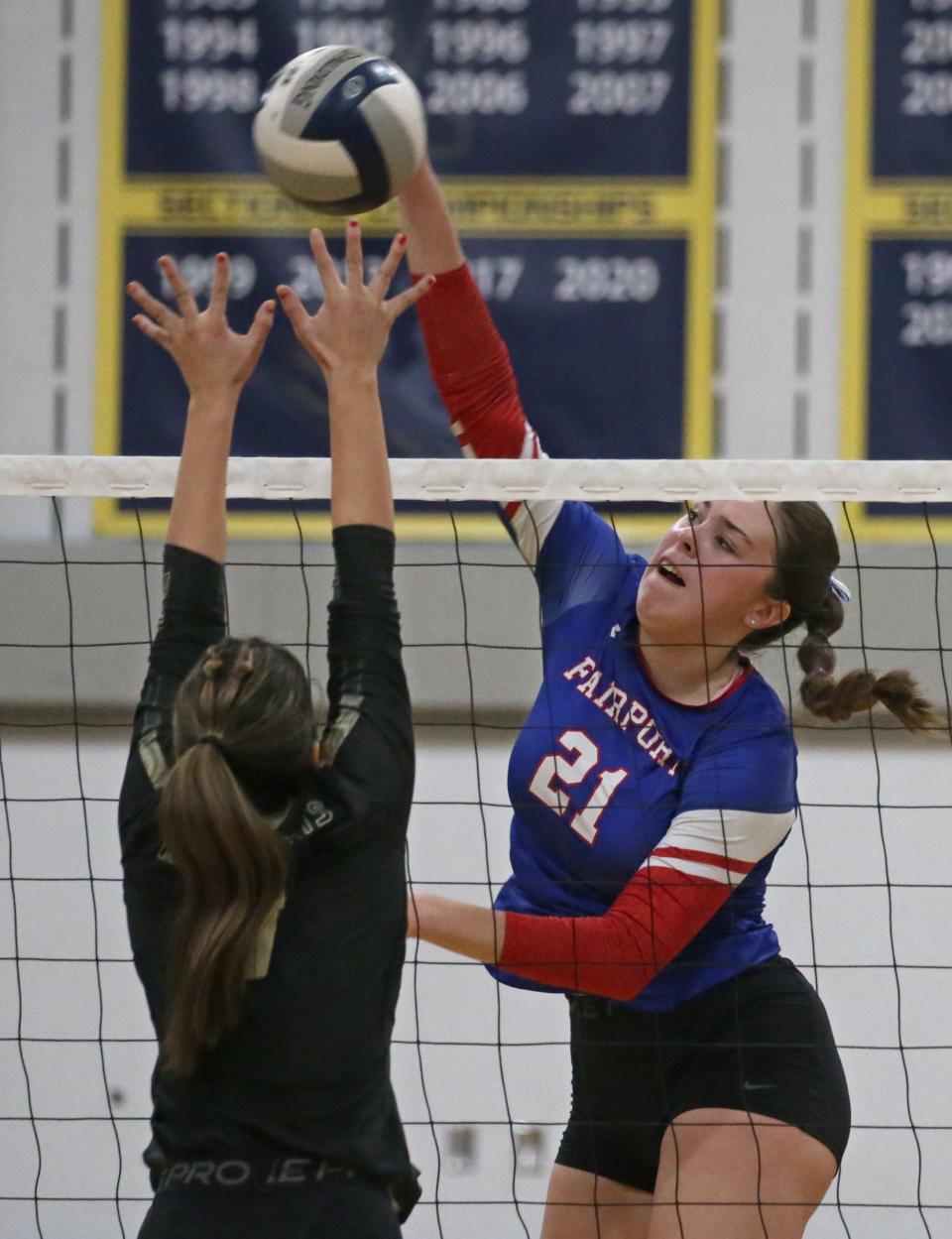 Fairport's Meghan Clifford sends in a spike over Rush-Henrietta's Avery Vacanti.