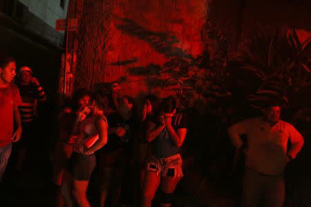 Residents are seen during a fire at Educando neighbourhood, a branch of the Rio Negro, a tributary to the Amazon river, in the city of Manaus, Brazil December 17, 2018. REUTERS/Bruno Kelly