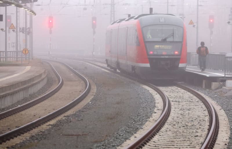 An S-Bahn train stands in the fog at the main station. The German Train Drivers' Union (GDL) has called for another 24-hour strike in the collective bargaining dispute at Deutsche Bahn for passenger and freight transport. Bernd Wüstneck/dpa
