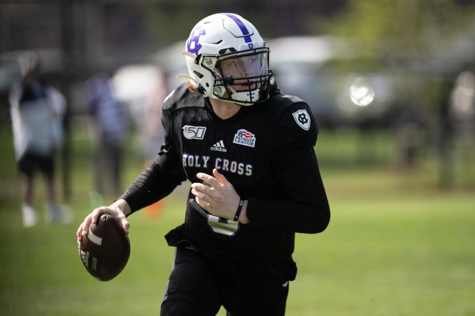 Quarterback Matthew Sluka drops back to pass during the Holy Cross spring game in April.