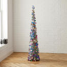 This undated photo shows West Elm's slim pop-up cone tree, clad in silver tinsel and dressed in multicolored paillettes. It's a good size for a small apartment or entryway. (West Elm via AP)