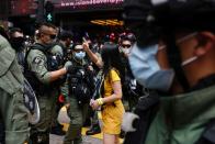 Pro-democracy protester argues with police before a protest in Hong Kong