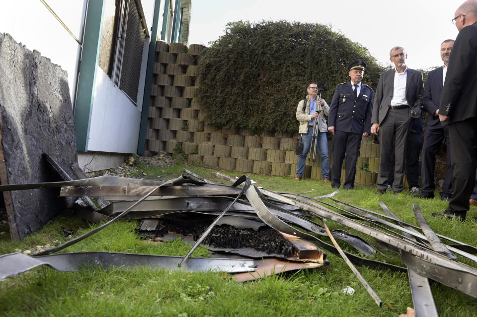 Saxony's Interior Minister Armin Schuster encounters the remains of the fire during his tour of the Spree Hotel in Bautzen, Germany, Saturday Oct. 29, 2022. The week before the arrival of refugees from Ukraine, a suspected arson attack occurred on the building. (Heiko Rebsch/dpa via AP).