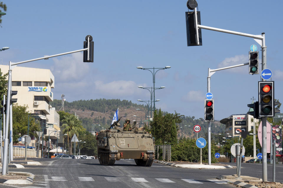 Israeli soldiers drive an armored personal carrier (APC) in the northern Israeli city of Kiryat Shmona, Friday, Oct. 20, 2023. The Israeli military announced Friday it would evacuate Kiryat Shmona, a city close to the border with Lebanon. Three residents were injured Thursday after the town came under cross-border fire from militants in Lebanon. (AP Photo/Baz Ratner)