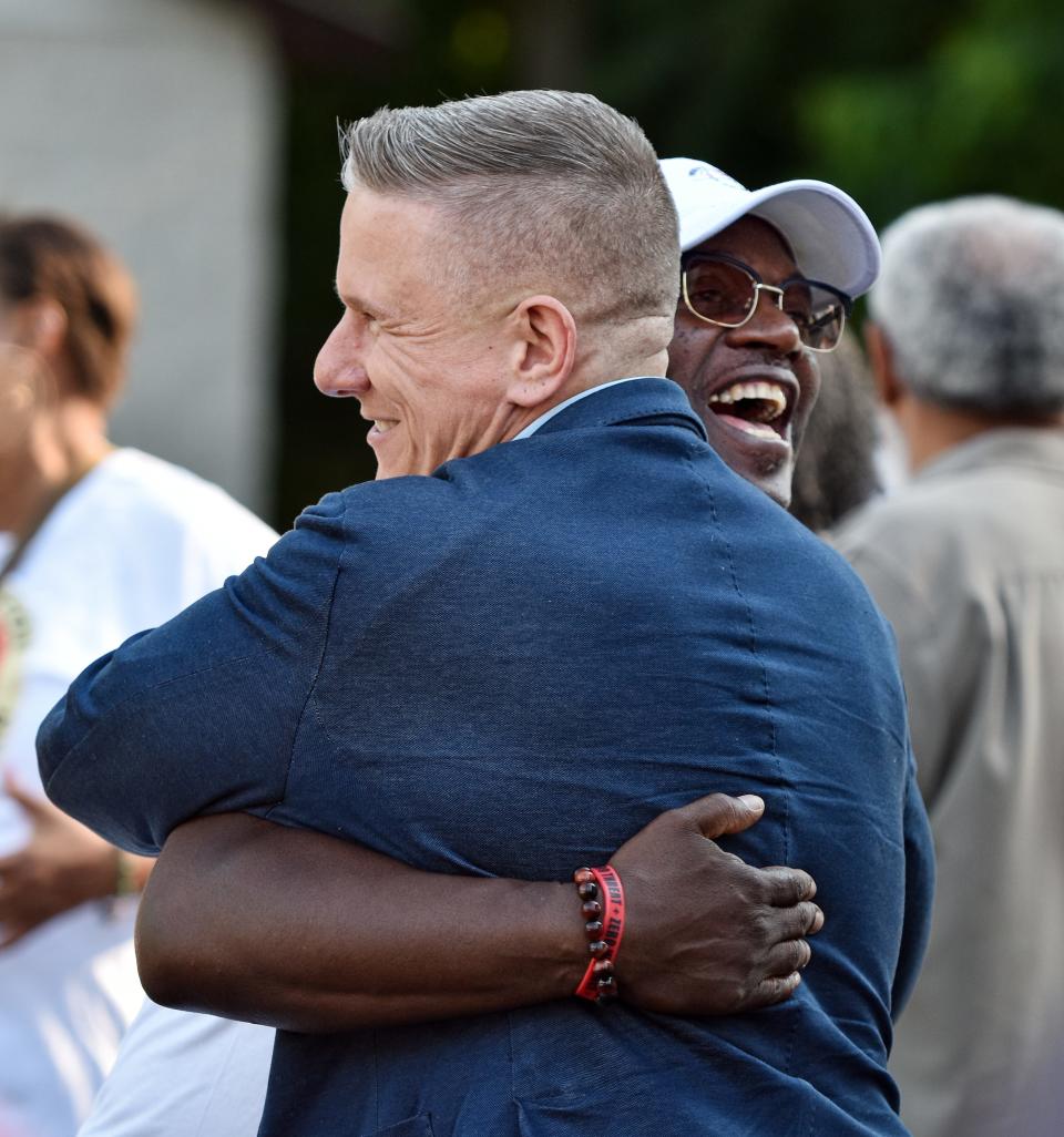 Bobby DiCello, left, the Walker family attorney, hugs pastor Robert DeJournett during a memorial for Jayland Walker Thursday in Akron.