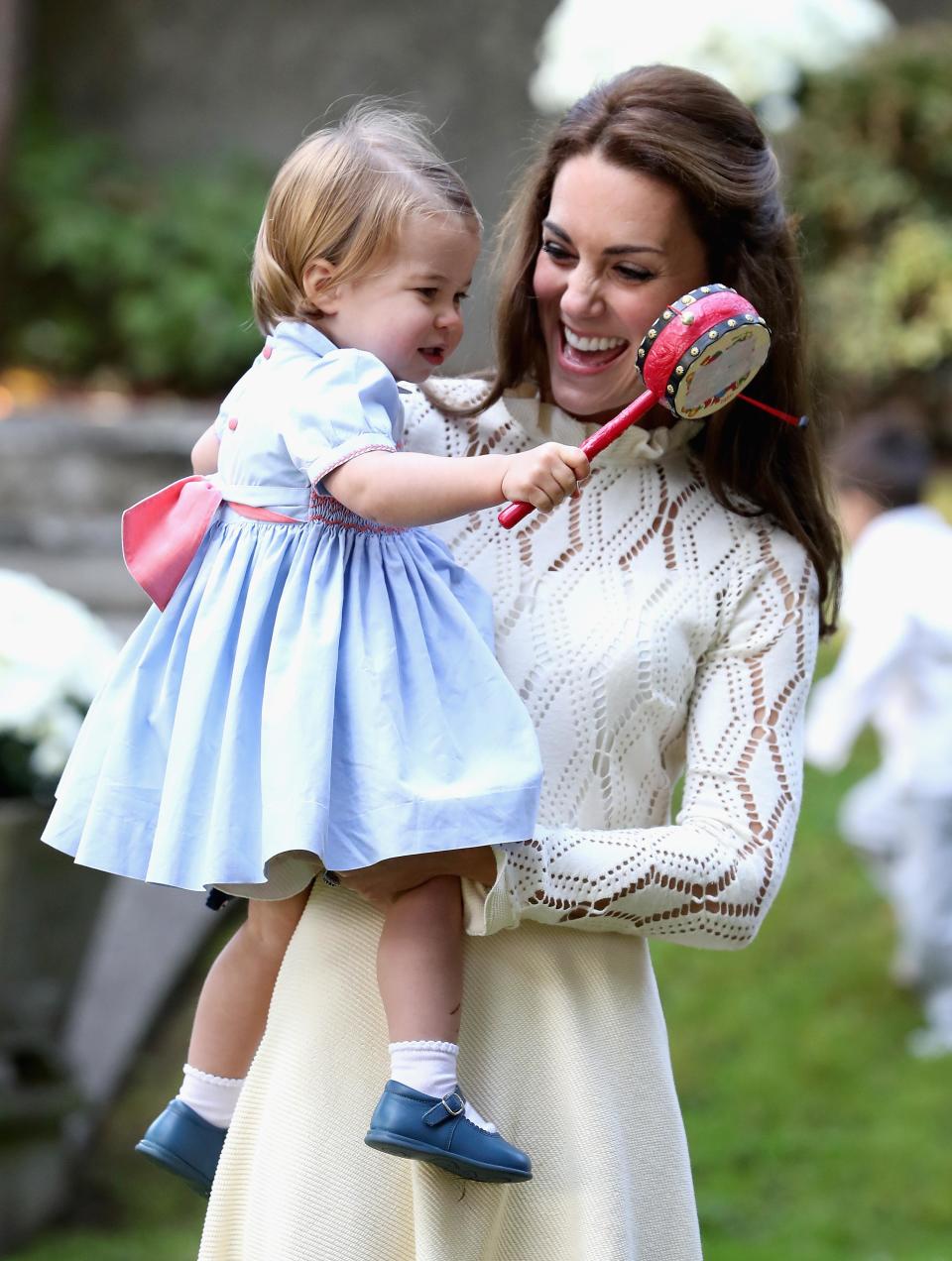 <p>The Duchess and little Charlotte looked adorable enjoying some light-hearted fun at a children's party.</p>