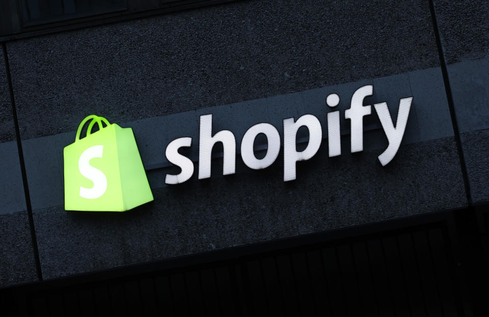 BERLIN, GERMANY - DECEMBER 14: The corporate logo of e-commerce company Shopify hangs at the building that contains the offices of Shopify Commerce Germany GmbH on December 14, 2023 in Berlin, Germany. Shopify is a leading, Canada-based company that enables online and brick-and-mortar commerce. (Photo by Sean Gallup/Getty Images)