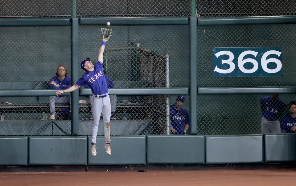 Evan Carter makes a leaping catch to start a double play in the eighth inning of Game 1.