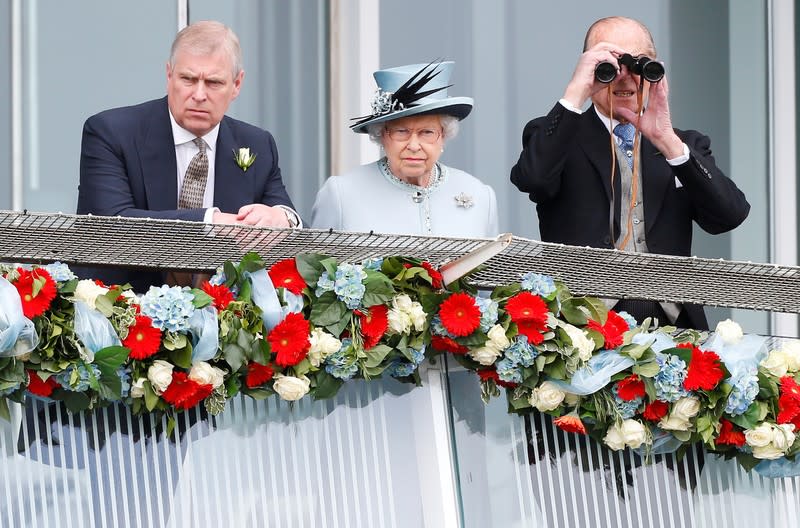 FILE PHOTO: Britain's Queen Elizabeth watches the Epsom Derby with Prince Andrew and Prince Philip, the Duke of Edinburgh, in Epsom, south of London