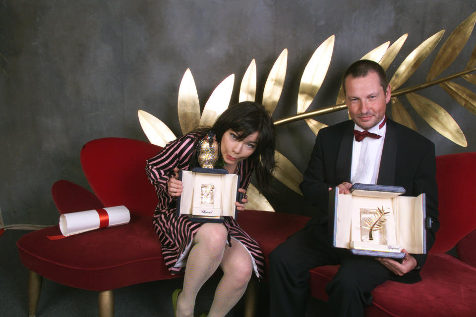 Actor Björk and director Lars von Trier hold up their Golden Palm awards for their movie "Dancer in the Dark" at the Cannes Film Festival in 2000.