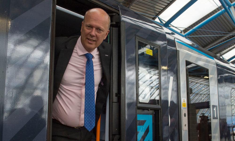 Chris Grayling leaning out of a train