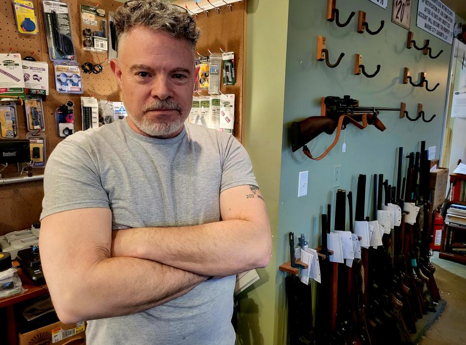 Marine City Gunsmith owner Jesse White stands in his shop on Wednesday, March 22, 2023.