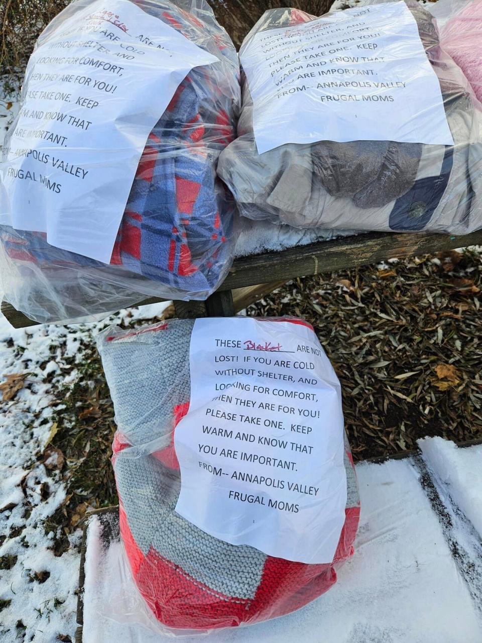The Annapolis Valley Frugal Moms Society recently started leaving these bags of blankets and winter clothes in outdoor public spaces in the Annapolis Valley.