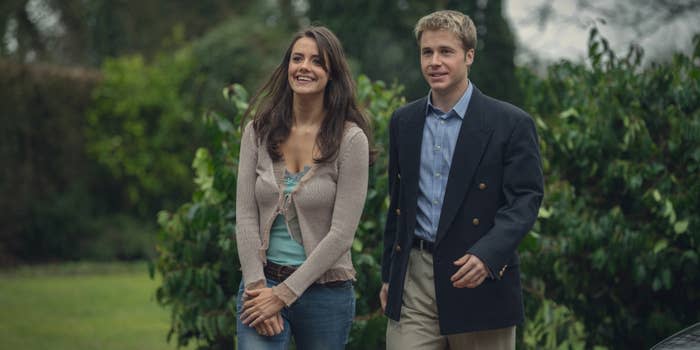 two people walking outside with trees behind them