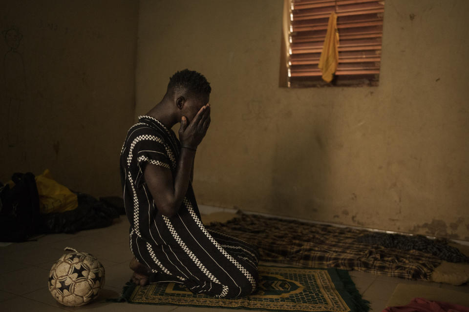 Papa Dieye, 19, prays in his father’s home in Diogo, Senegal, Monday, Aug. 28, 2023. (AP Photo/Felipe Dana)
