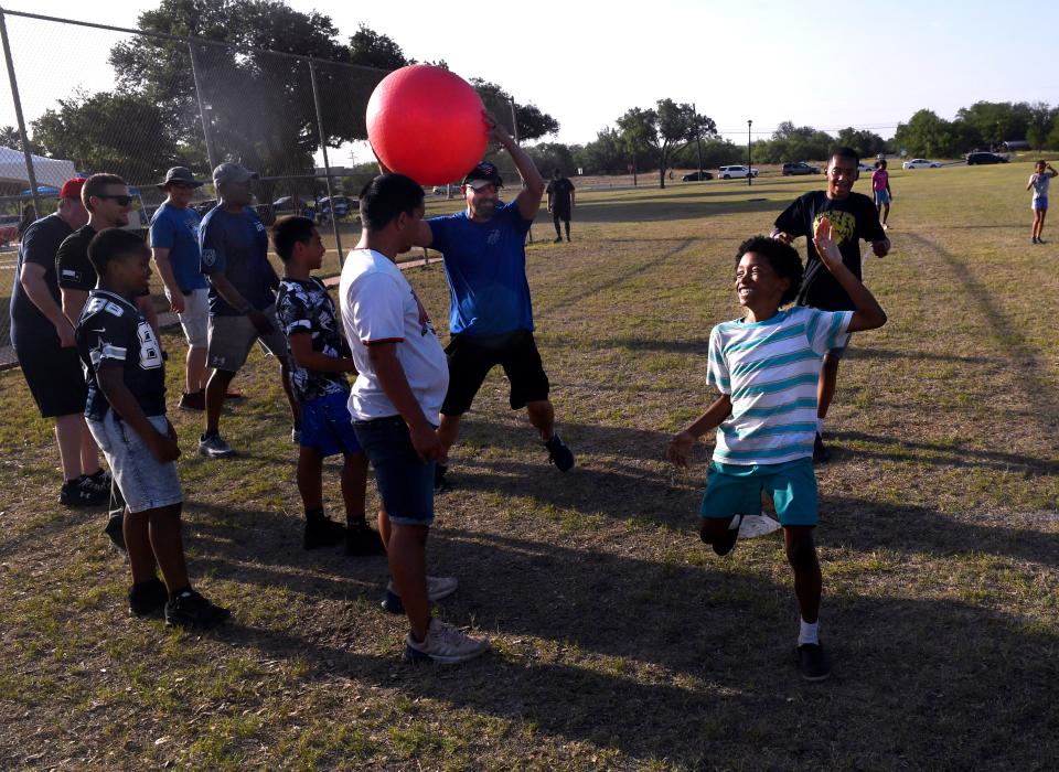 Children and adults from the Abilene Police Department, Let Us Breathe and other groups play kickball Friday at Stevenson Park. The game kicked-off one of the weekend's Juneteenth holiday weekend.