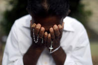 A person mourns at a grave of a victim, two days after a string of suicide bomb attacks on churches and luxury hotels across the island on Easter Sunday, at Sellakanda Catholic cemetery in Negombo, Sri Lanka April 23, 2019. REUTERS/Athit Perawongmetha