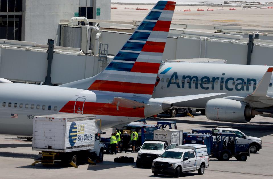 American Airline planes are parked at their Miami International Airport terminal gates in May.