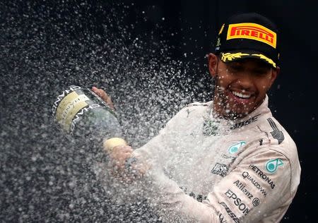 Formula One - F1 - Brazilian Grand Prix - Circuit of Interlagos, Sao Paulo, Brazil - 13/11/2016 - Mercedes' Lewis Hamilton of Britain sprays champagne during the victory ceremony after winning the race. REUTERS/Paulo Whitaker