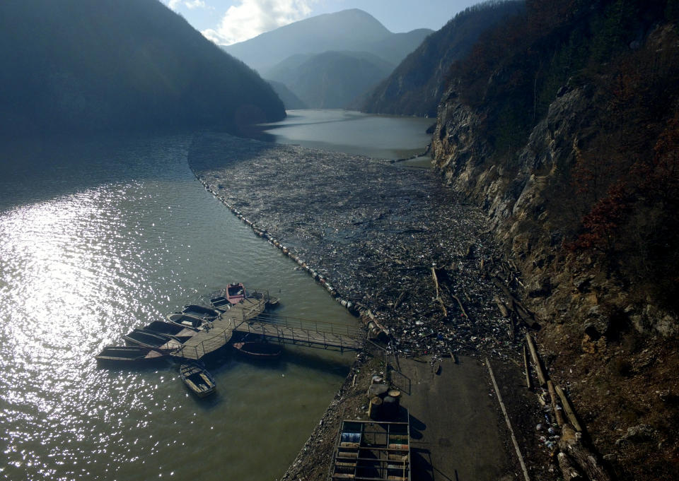 This aerial photo shows plastic bottles, wooden planks, rusty barrels and other garbage clogging the Drina river near the eastern Bosnian town of Visegrad, Bosnia, Tuesday, Jan. 5, 2021. Further upstream, the Drina tributaries in Montenegro, Serbia and Bosnia are carrying even more waste after the swollen rivers surged over the the landfills by their banks. The Balkan nations have poor waste management and tons of garbage routinely end up in rivers. (AP Photo/Eldar Emric)