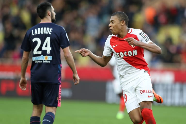 Monaco's Kylian Mbappe (R) celebrates after scoring a goal during their match against Bordeaux (GB) on March 11, 2017 in Monaco