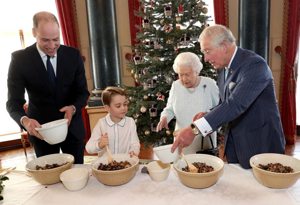 Prince William, Prince George, Queen Elizabeth, and Prince Charles working on their Christmas puddings