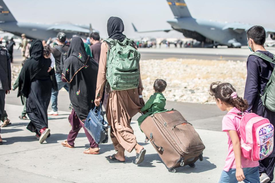 Refugees and other personnel from Afghanistan board an evacuation flight on Aug. 24, 2021, in Kabul.
