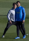 Boca Junior's coach Guillermo Barros Schelotto, left, stands behind Carlos Tevez during a training session in Madrid, Spain, Thursday, Dec. 6, 2018. The Copa Libertadores Final will be played on Dec. 9 in Spain at Real Madrid's stadium for security reasons after River Plate fans last Saturday attacked the Boca Junior team bus heading into the Buenos Aires stadium for the meeting of Argentina's fiercest soccer rivals. (AP Photo/Paul White)