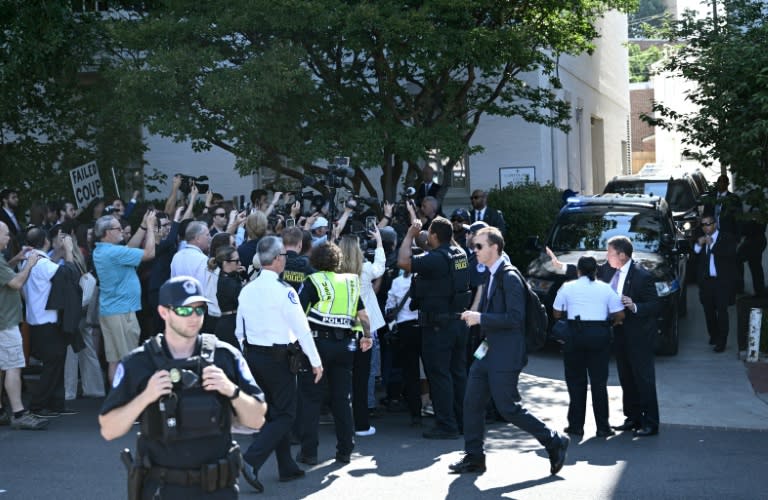 US Capitol police officers hold back media and protesters as former US president Donald Trump arrives for a meeting with US House Republicans on June 13, 2024 (Brendan SMIALOWSKI)