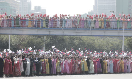 North Korean people greet South Korean President Moon Jae-in and North Korean leader Kim Jong Un during a car parade in Pyongyang, North Korea, September 18, 2018. Pyeongyang Press Corps/Pool via REUTERS