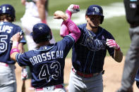 Tampa Bay Rays' Willy Adames, right, is congratulated by teammate Mike Brosseau after hitting a three-run home run against the Oakland Athletics during the fifth inning of a baseball game in Oakland, Calif., Sunday, May 9, 2021. (AP Photo/Jed Jacobsohn)