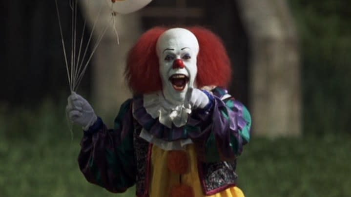 Pennywise stands and points in Stephen King's It.