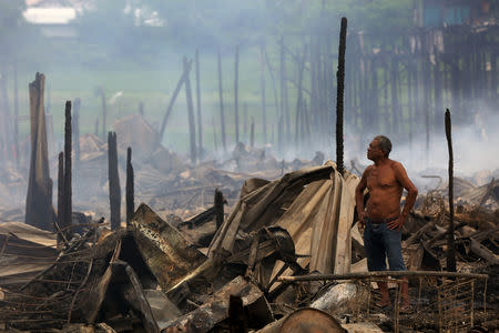 A resident is seen after a fire at Educandos neighbourhood, a branch of the Rio Negro, a tributary to the Amazon river, in the city of Manaus, Brazil December 18, 2018. REUTERS/Bruno Kelly