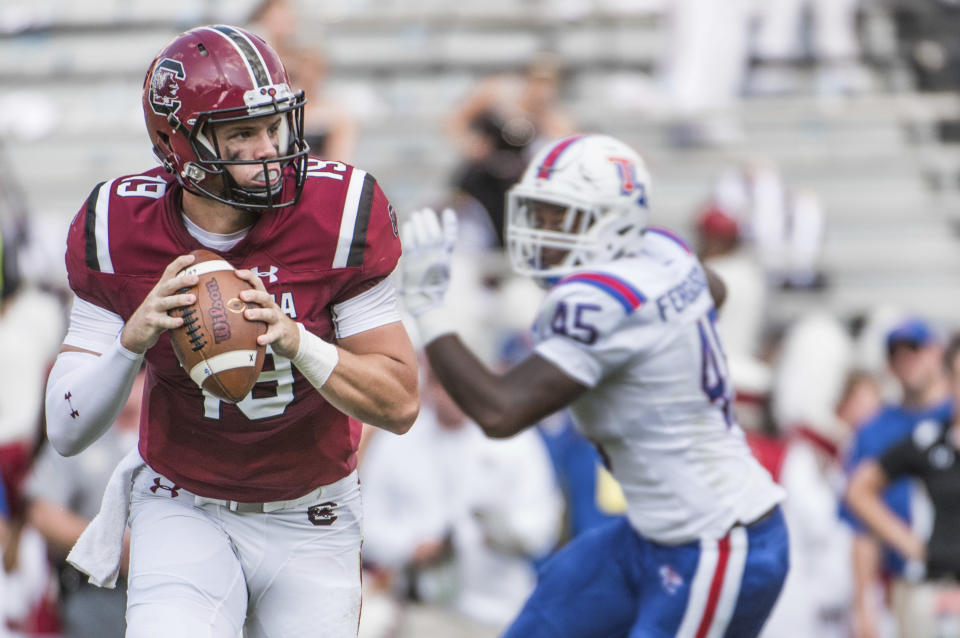 South Carolina quarterback Jake Bentley (19) looks for an open teammate against Louisiana Tech defensive end Jaylon Ferguson (45) during the first half of an NCAA college football game Saturday, Sept. 23, 2017, in Columbia, S.C. (AP Photo/Sean Rayford)