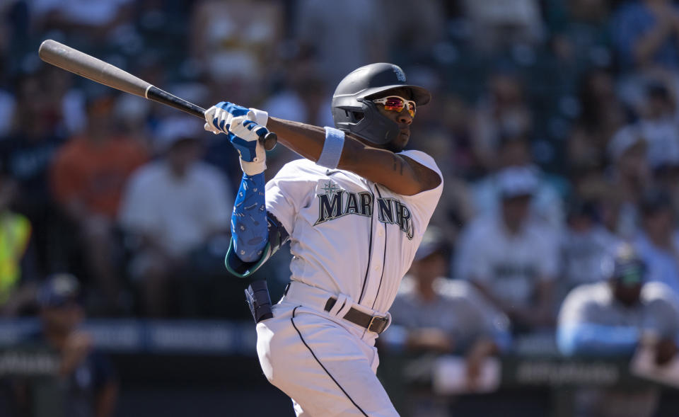 Seattle Mariners' Shed Long Jr. hits a grand slam off Tampa Bay Rays relief pitcher Diego Castillo that also scored Dylan Moore, Jake Bauers and Luis Torrens during the 10th inning of a baseball game, Sunday, June 20, 2021, in Seattle. (AP Photo/Stephen Brashear)