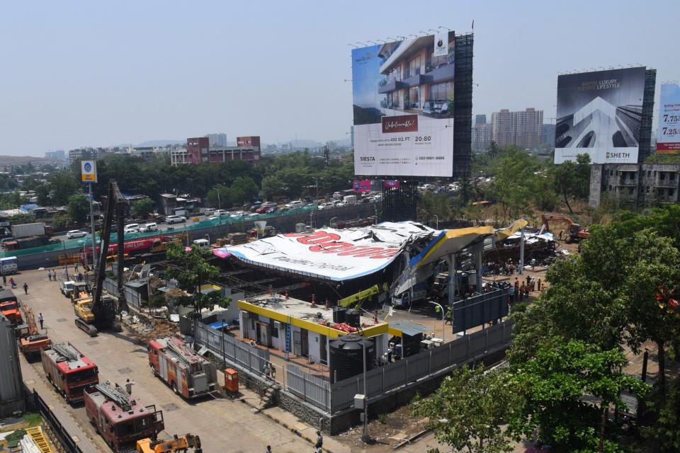 Emergency vehicles are parked at the site a day after billboard collapsed over a gas station following a storm, in Mumbai on May 14, 2024.